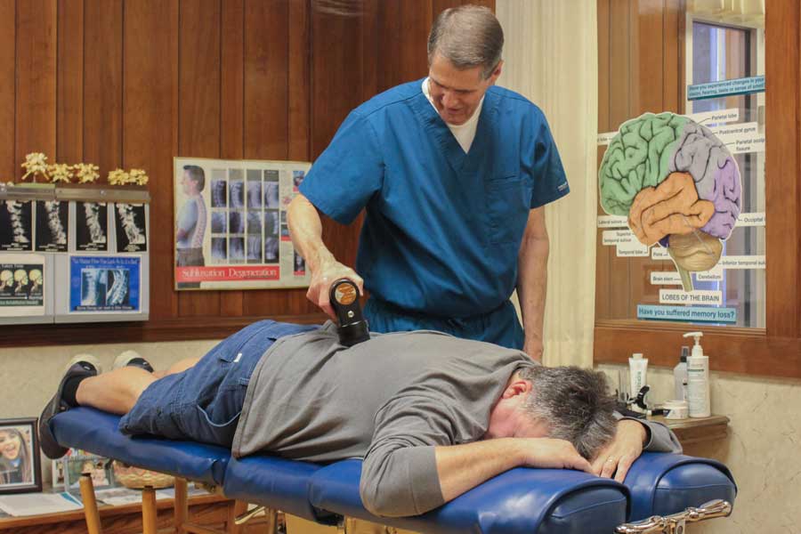 Dr. David Naylor Working on Patient | Chiropractic & Acupuncture Services in Burlington, NC